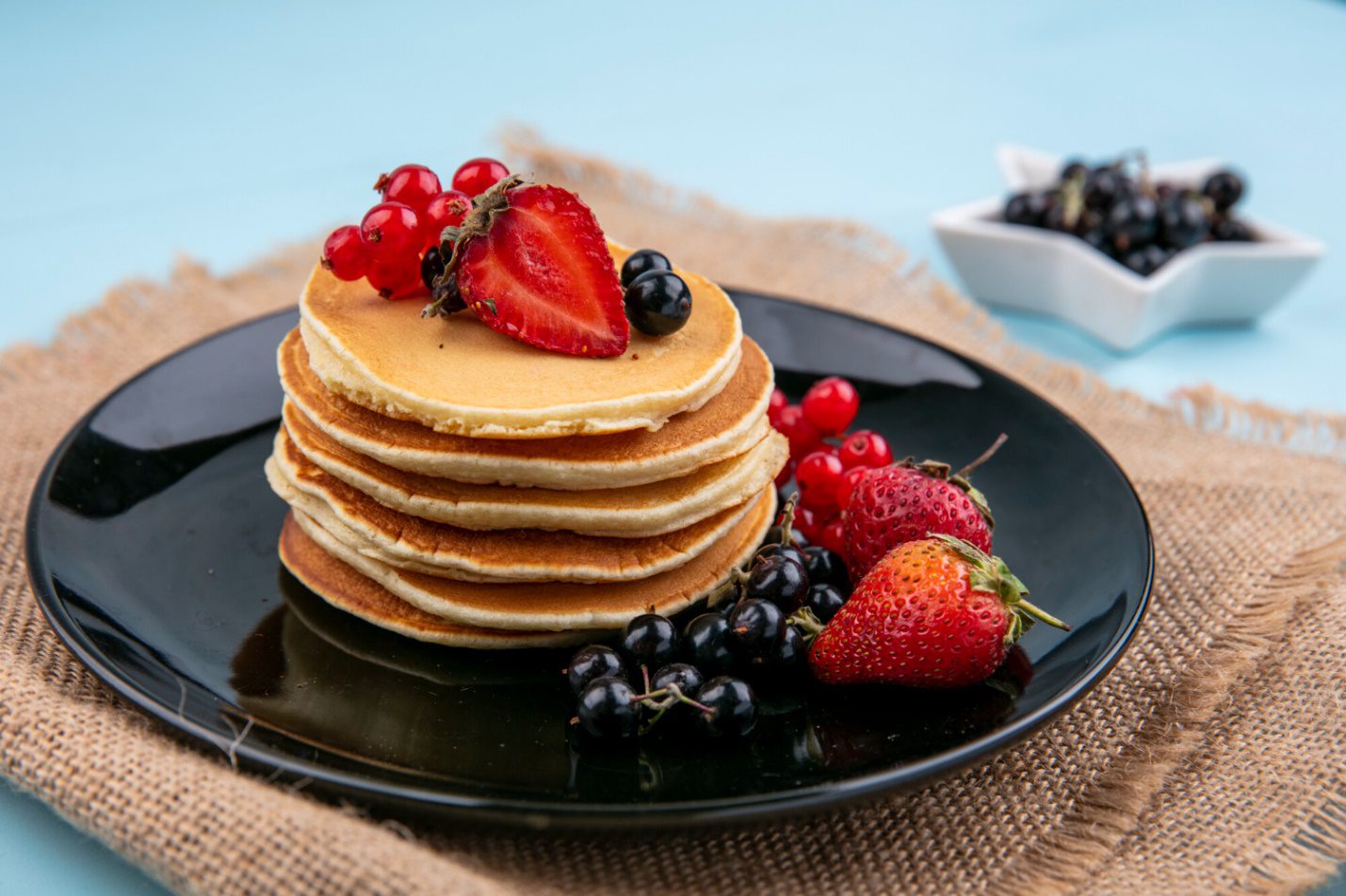C:\Users\Talha\Downloads\front-view-pancakes-with-red-black-currants-strawberries-black-plate-beige-napkin.jpg