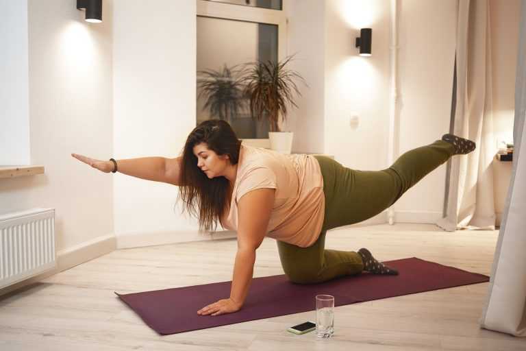 Overweight woman doing physical training