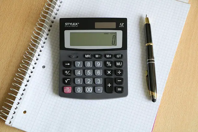 calculator, ballpoint pen, block